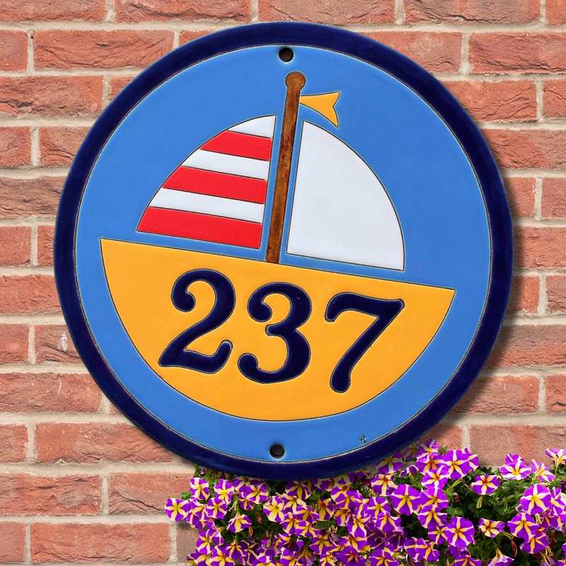 House number with a sailing boat